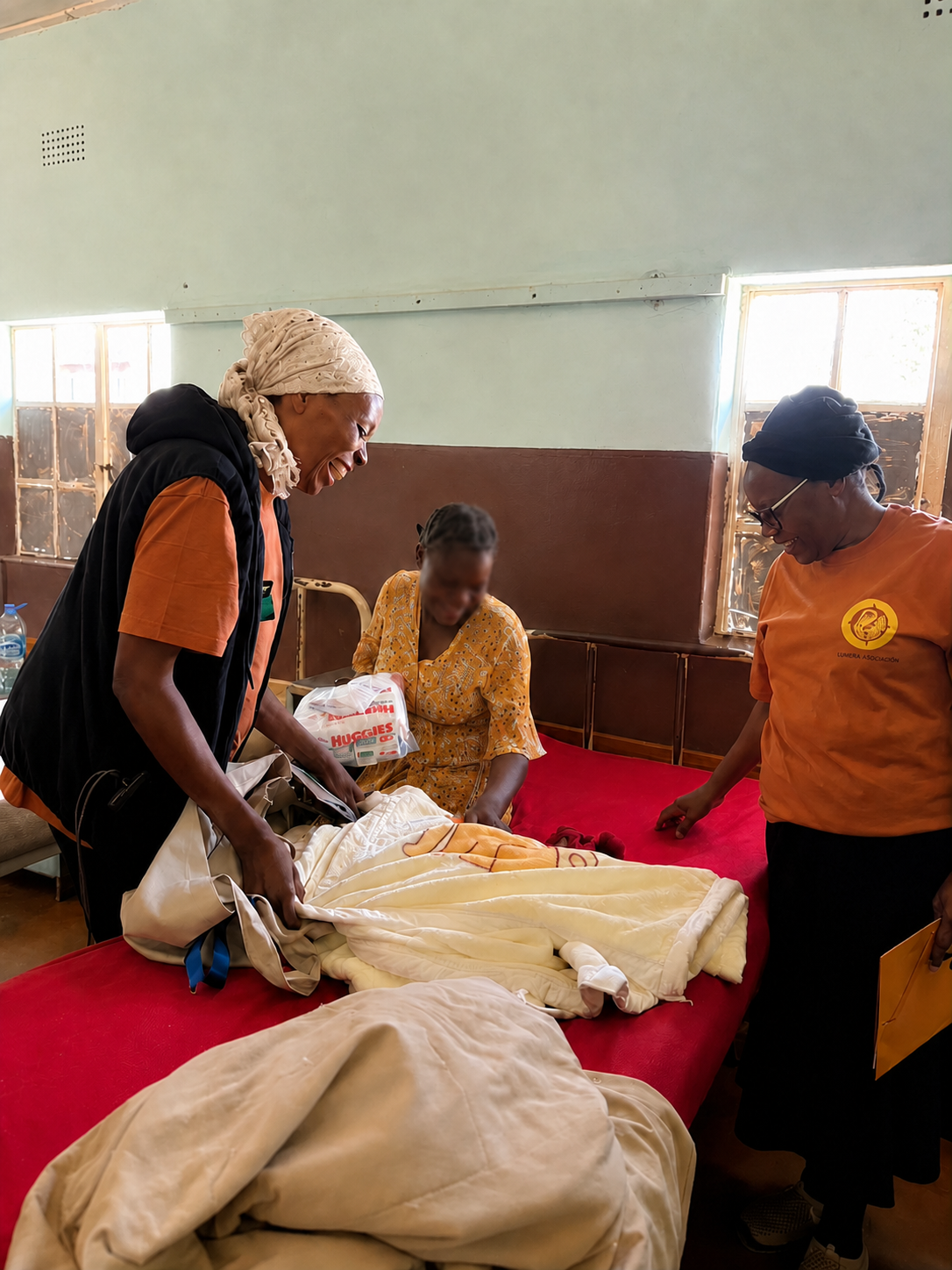 Lumera volunteers presenting essential care items to a mother