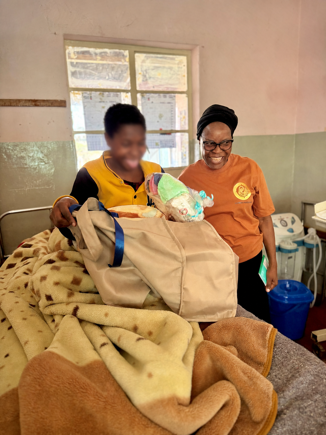 A mother receiving a Grace Mother and Baby Care Kit